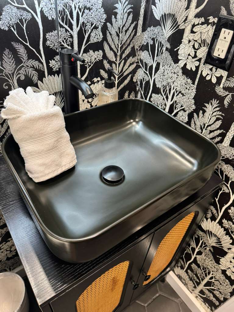 Real LOOM work showing the black bathroom sink clean and polished